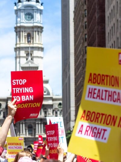 Image of people at a march with signs supporting abortion access