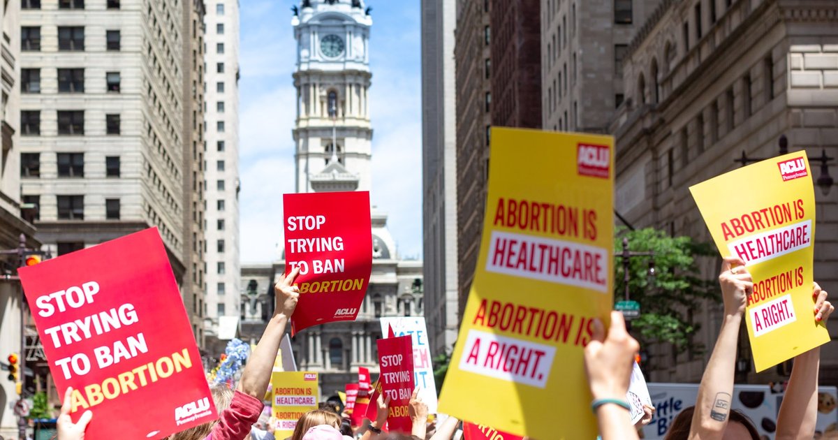 Image of people at a march with signs supporting abortion access