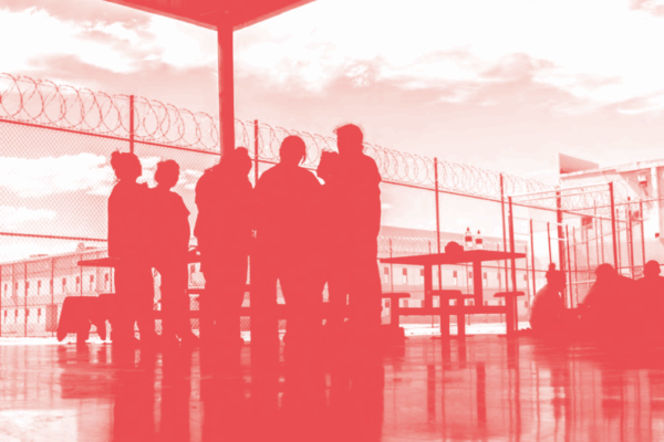 Image of people standing in a detention facility
