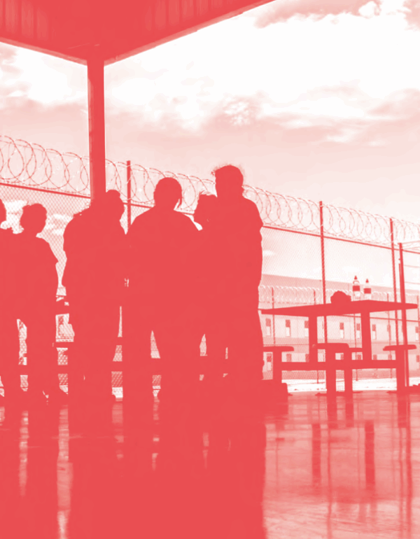 Image of people standing in a detention facility