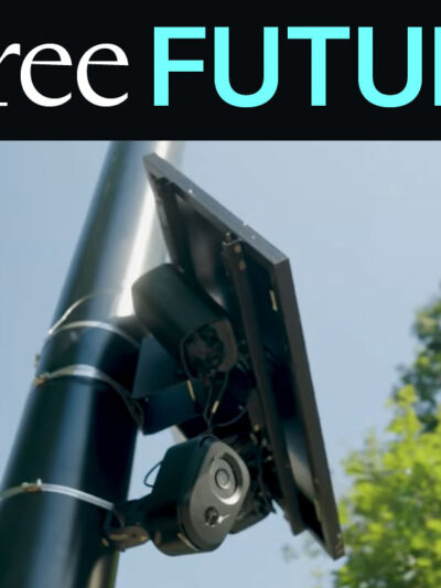 A license plate reader against sky and trees