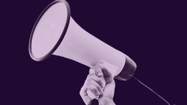 Purple graphic with an image of a hand holding a megaphone and text that says "Protect free speech in Wyoming"