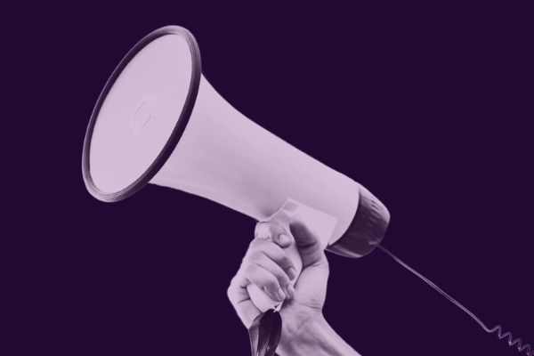 Purple graphic with an image of a hand holding a megaphone and text that says "Protect free speech in Wyoming"