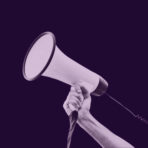 Purple graphic with an image of a hand holding a megaphone and text that says "Protect free speech in Wyoming"