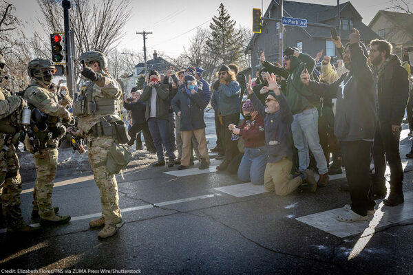 A photos of demonstrators in Minneapolis filming federal agents.