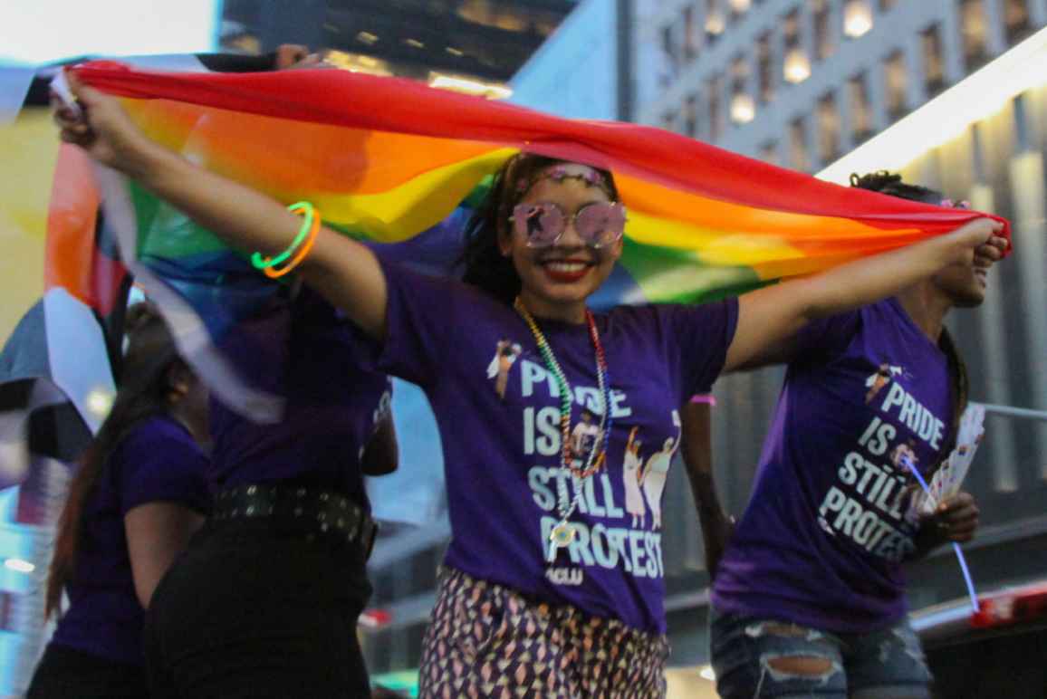 Person wearing a "Pride is still protest" t-shirt