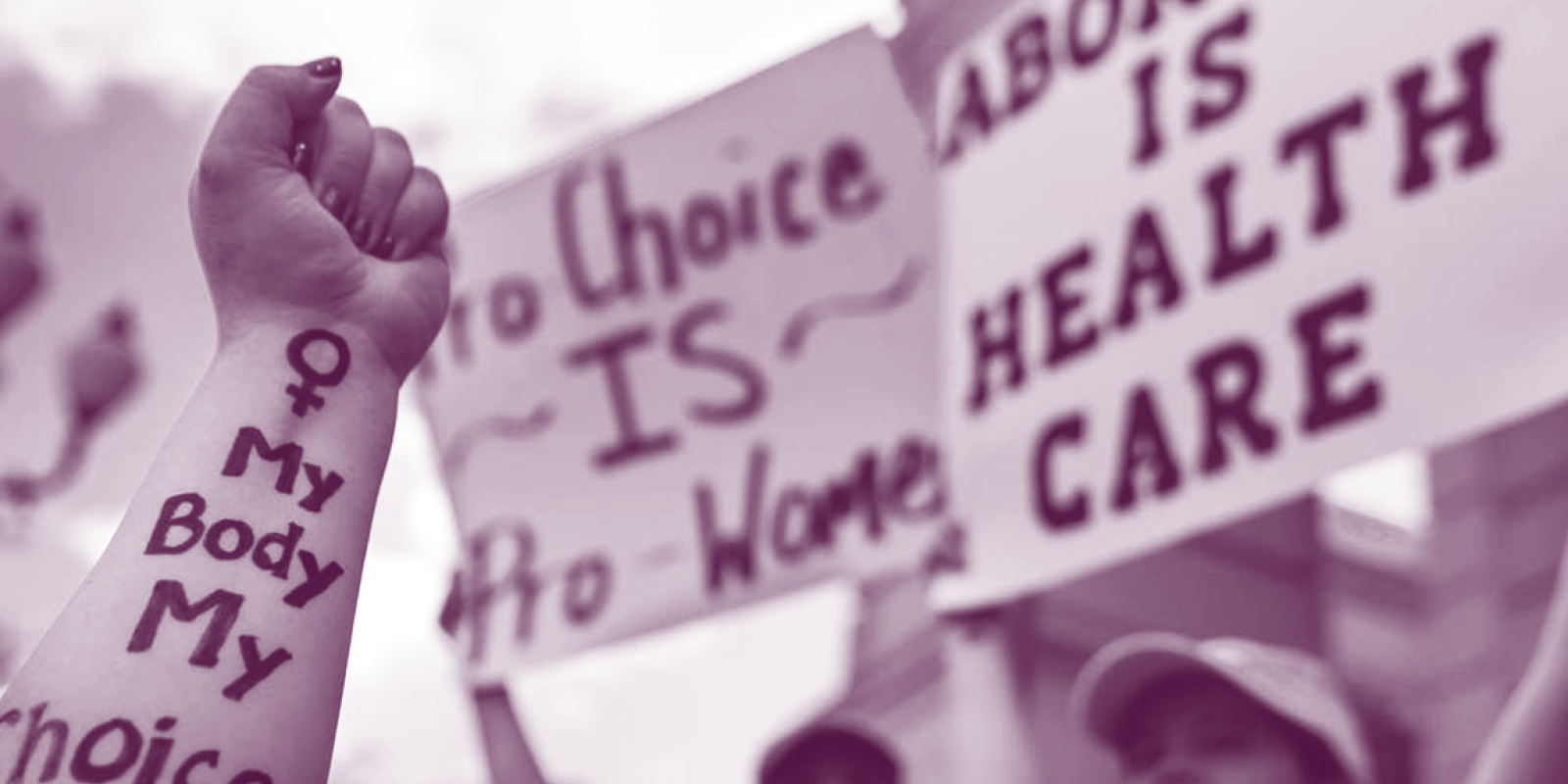 Image of a person's arm with the text written on it, "my body my choice."