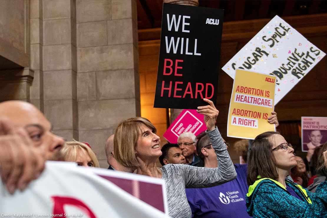 Supporters of abortion-rights attend a reproductive freedom rally at state capitol in Nebraska, holding ACLU signs that read "We will be heard" and "abortion is healthcare."