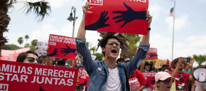 Image of a person holding a protest sign 