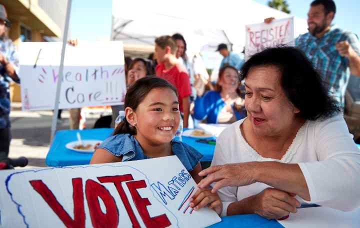 image of a person with a sign that reads, "vote matters"
