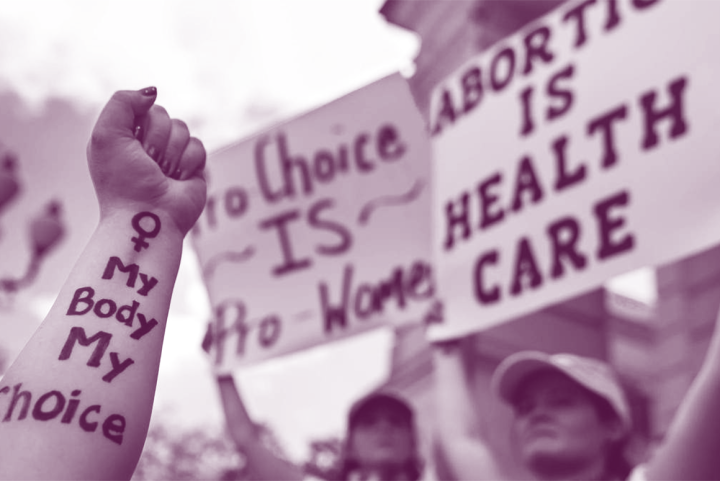 Image of protest signs and an arm that has the text, "My body my choice."
