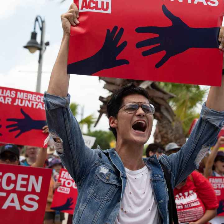 Image of a person holding a protest sign 