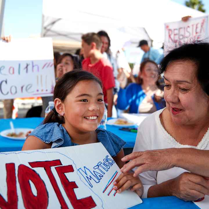 image of a person with a sign that reads, "vote matters"