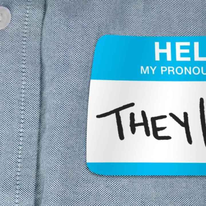 Image of a shirt with a pronoun tag that reads, "they/them"