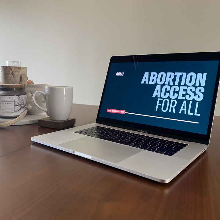 Image of a laptop with the background, "ABORTION ACCESS FOR ALL."