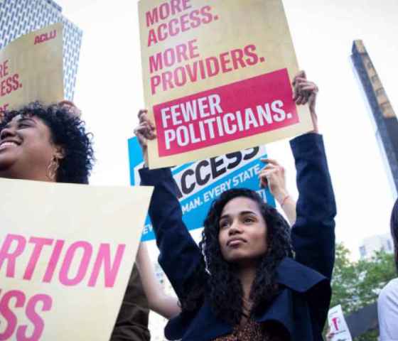 Image of people at a protest with signs supporting abortion access